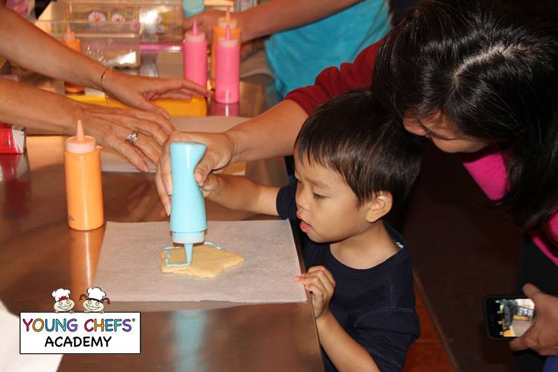 A little boy baking at Young Chefs Academy